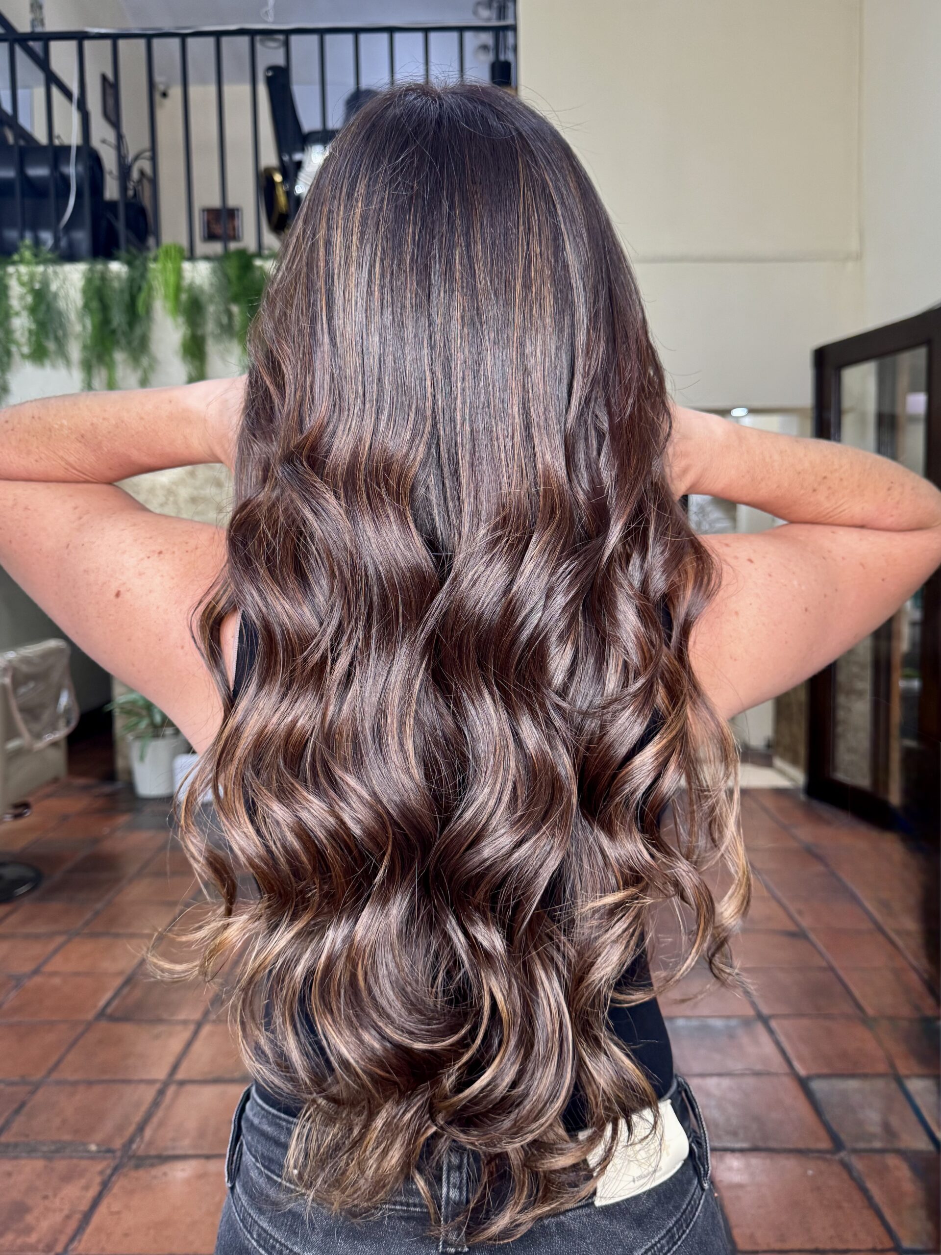 Resultado de balayage en cabello castaño con degradado suave en tonos miel avellana y ondas ligeras